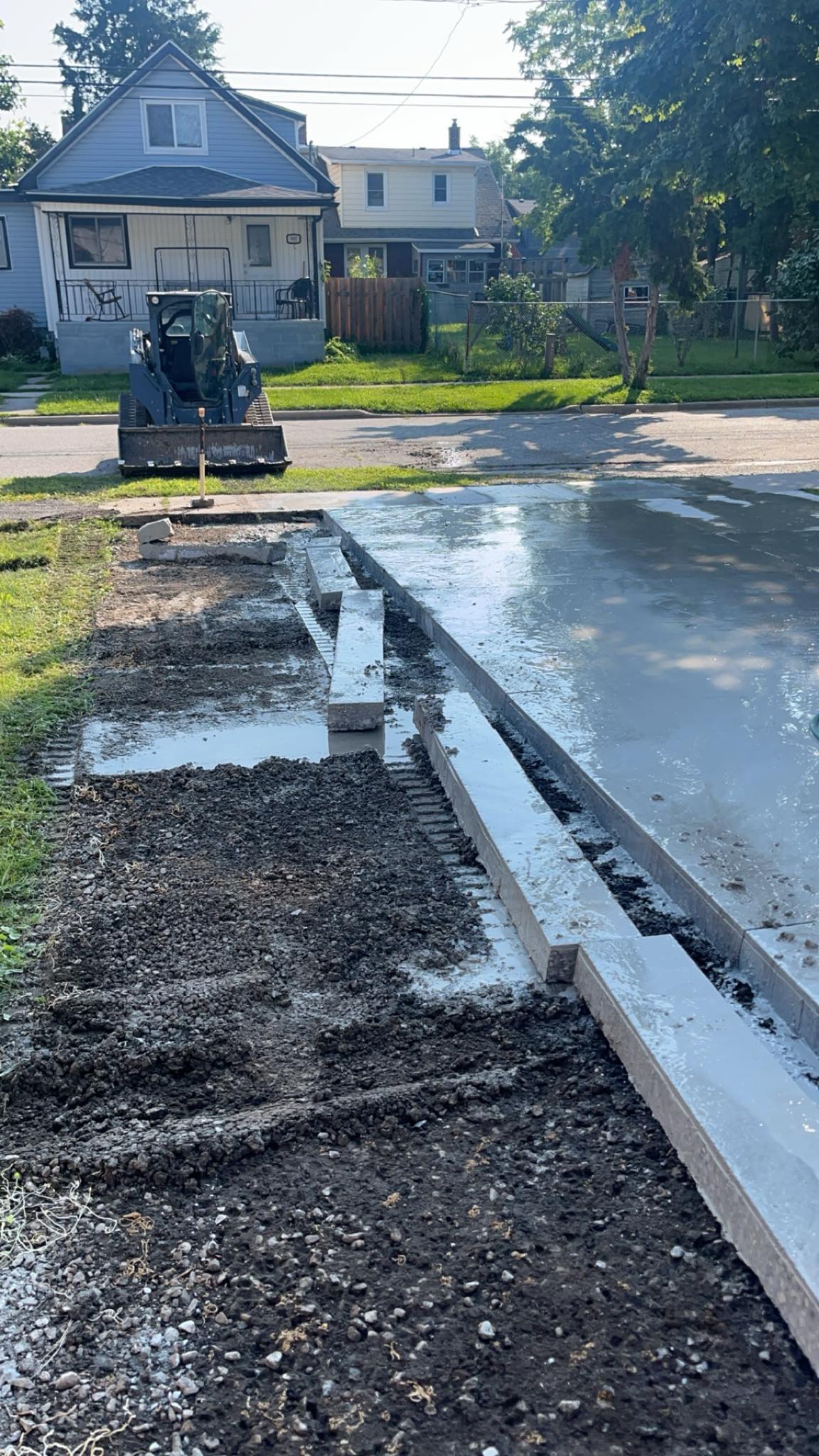 Installing fresh new concrete slabs onto a driveway